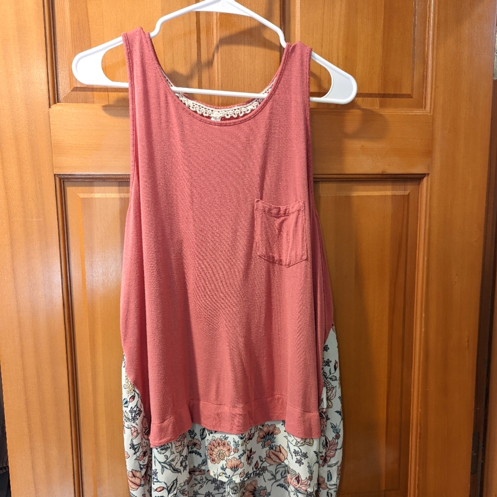 A fun pink tank top with a floral ruffled hem. Possibly a short dress.